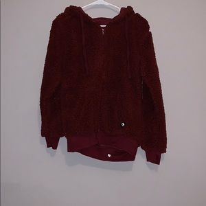 was fuzzy maroon zip up